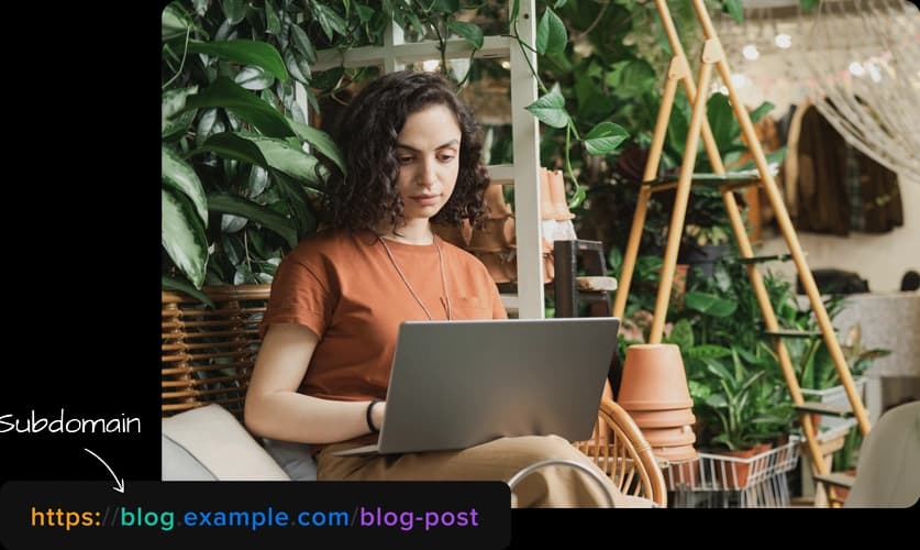 Woman working on laptop and subdomain example